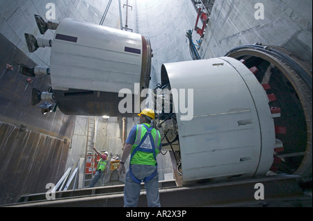 A Tunnel Boring Machine (TBM) is lowered down an access shaft before being assembled and launched on its underground excavation. Stock Photo