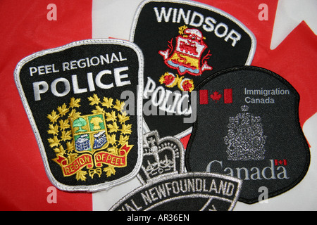 Police immigration and law enforcemment agencies of Canada patches and flag Stock Photo