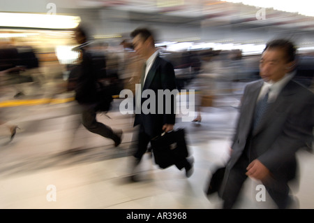Commuters on their way to work in a railway station during the Tokyo rush hour Japan Stock Photo