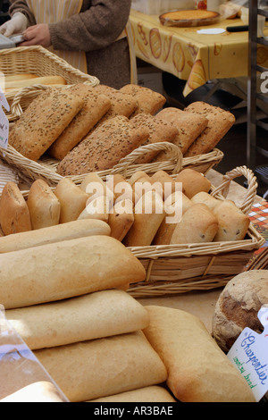 Baskets of French bread at market Different varieties in wicker baskets Some wording in English Stock Photo