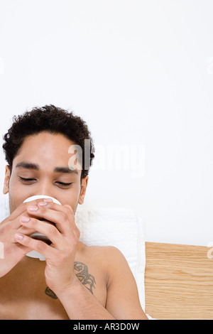 Young man drinking tea Stock Photo