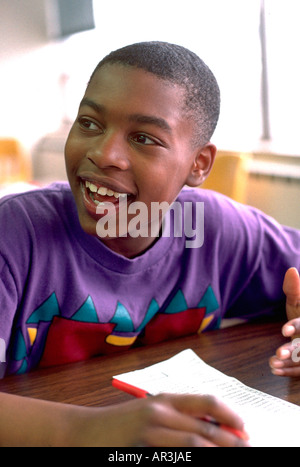 Youth age 12 reading in community after school study program. St Paul Minnesota USA Stock Photo
