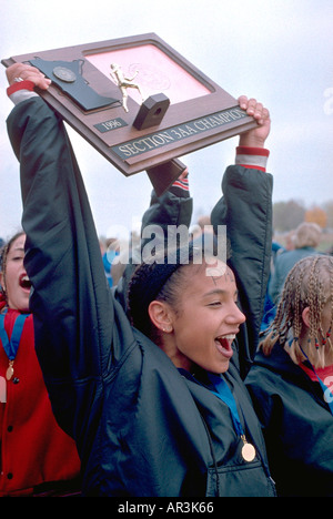Cross country champion age 17 celebrating win at regional race. Park Reserve Spring Lake Hastings Minnesota USA Stock Photo