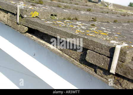 Roof repairs required to gable end verge of detached house where pointing has broken away below clipped concrete tile Stock Photo