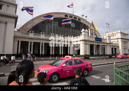 Front of Hua Lamphong Railway station with a passing taxi and pedestrians, Rama IV Road. Bangkok, Thailand. Stock Photo