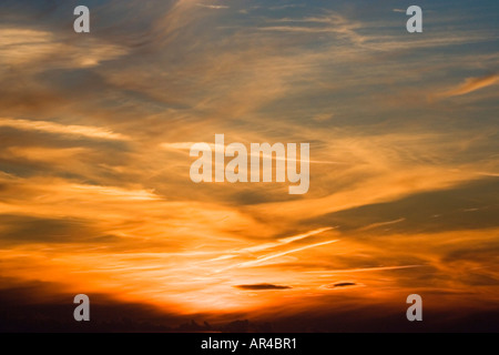 Aircraft con trails. Sunset over southern England. UK.  Rich colours. Aerial view coming in to land. Stock Photo
