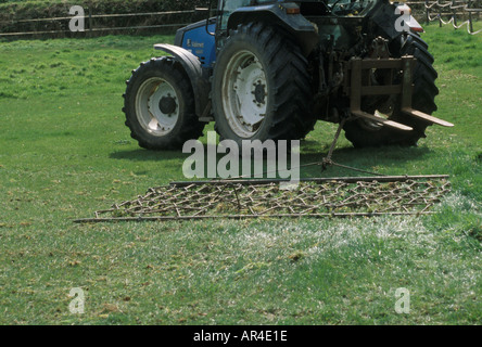 A Grass Harrow being towed by a tractor Stock Photo