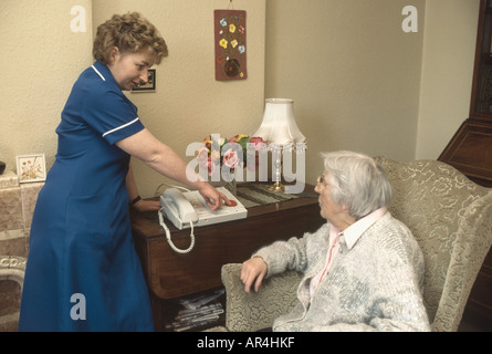 district nurse visiting elderly woman at home NHS Stock Photo
