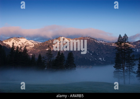 Sierra Nevada peaks and Olympic Valley with fog at dawn from the Resort at Squaw Creek Lake Tahoe California Stock Photo