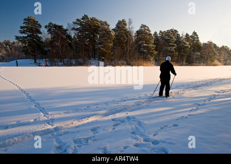 Skiers on Kottla Lake near Stockholm a popular destination for outings all year round Stock Photo