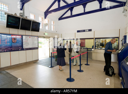 People queuing to buy a rail ticket at Hitchin railway station, Hertfordshire, England. Stock Photo