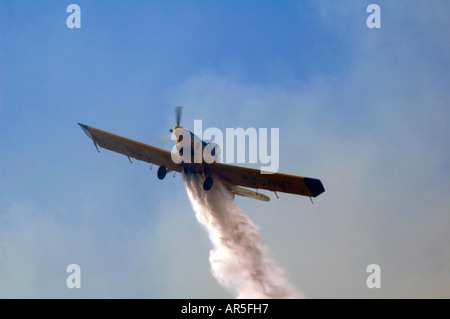An Air Tractor AT-802 Fire-fighting aircraft drops flame retardant on a massive forest wildfire in Israel Stock Photo