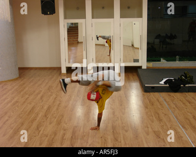 A break dancer performing one-handed freeze Stock Photo
