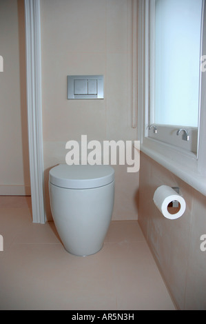 White Philippe Starck toilet in modern beige bathroom Stock Photo