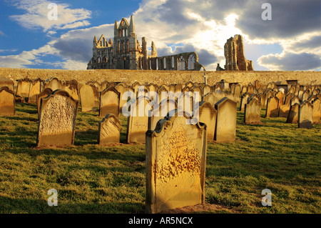 Whitby Abbey with grave stones at sunset Stock Photo