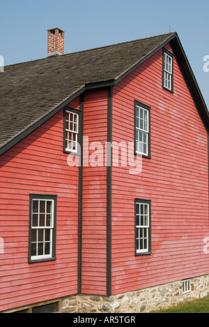 Residential house exterior with weathered red clapboard siding and a brick chimney, Eckley Miner's Village, tourist attraction in Pennsylvania, PA Stock Photo