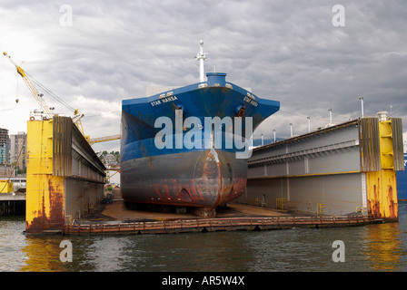 Ship in floating dry dock at a shipyard in North Vancouver. Stock Photo
