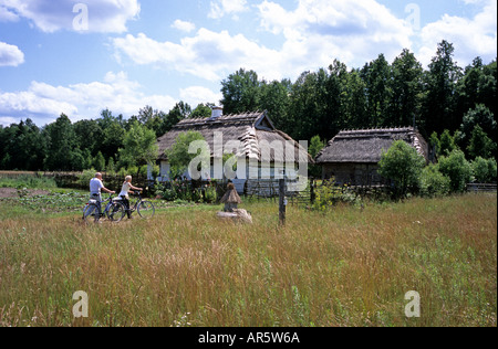Budy, museum of Polish Village huts and tourists on bikes Stock Photo