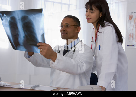 Multi-ethnic doctors looking at x-ray Stock Photo