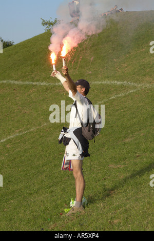 A man lightup fireworks to express his excitement after the WM game finished Olympia centrum Munich Germany Stock Photo