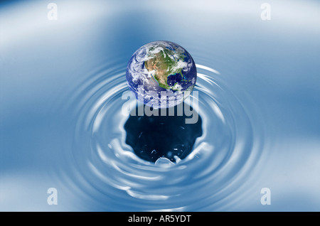 Globe falling into water digital composite Stock Photo