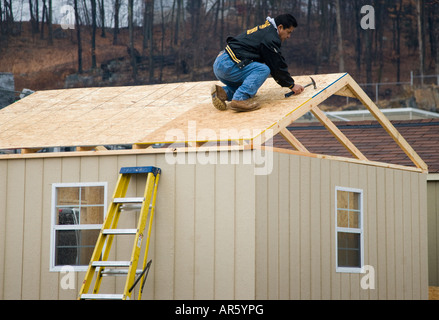 Man working on a roof Stock Photo