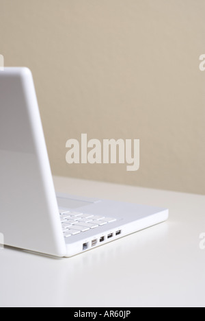 Empty workspace White laptop on a desk Stock Photo