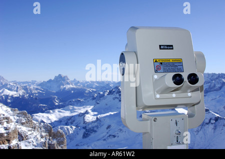 Coin-operated binoculars in front of snow covered landscape, Passo Pordoi, Dolomites, Italy, Europe Stock Photo