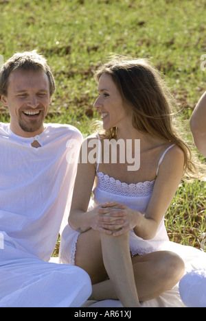 MR Three friends, a spanish woman, a brazilian woman and a sweedish man, enjoying themselves in the fields of Ibiza, Spain Stock Photo