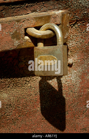 RUSTY METAL PADLOCK IN ABANDONED DOOR Stock Photo