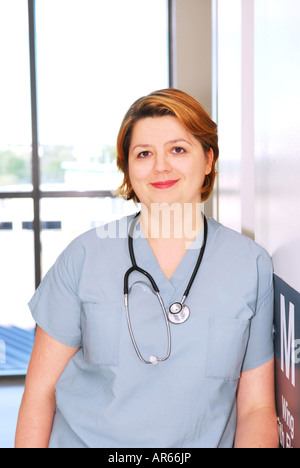 Portrait of a smiling nurse standing in a hospital corridor Stock Photo
