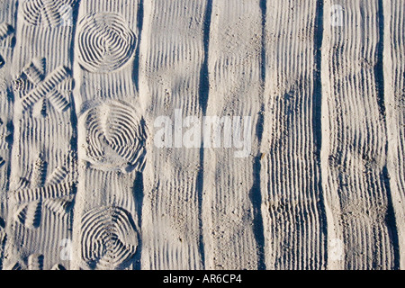 an overhead plan view of abstract patterns made in fine white sand with a rake Stock Photo
