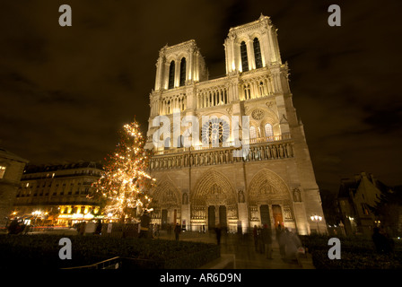 Notre Dame cathedral facade at night with Christmas tree Stock Photo