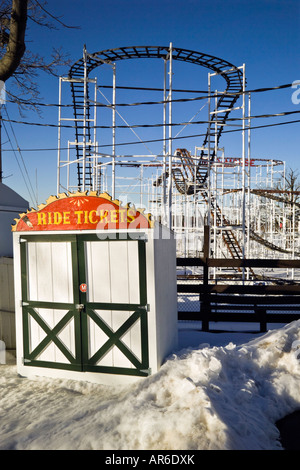 Ticket booth in front of empy rollercoaster track closed up for winter Stock Photo