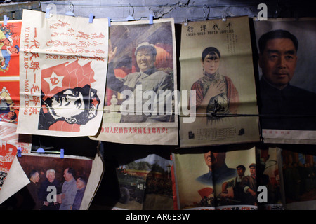 Communist propaganda posters hang for sale in an alley near to Houhai Lake, a popular destination for nightlife in Beijing. Stock Photo