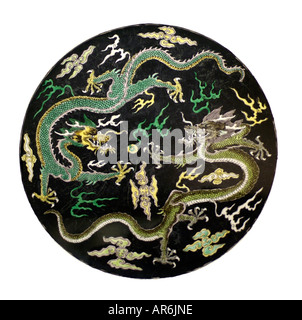 Oriental dragon plate snow sky pearl wisdom mythical beast green yellow ceramic plate pottery glazed fire tooth claw scale Stock Photo