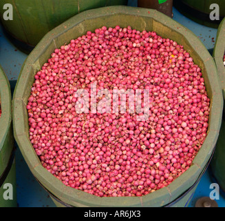red pepper corns corm seed husk skin whole unground uncrushed green tub barrel round sphere globe spherical wrinkle texture pile Stock Photo