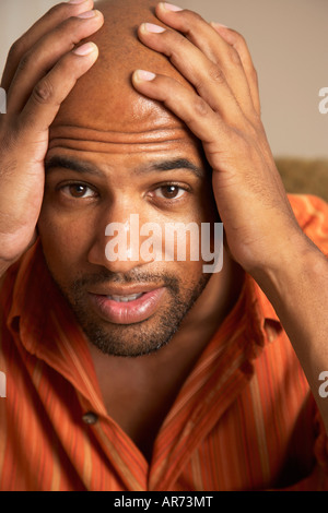 Mixed Race man with hands on head Stock Photo