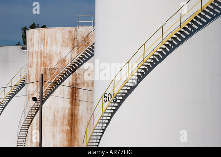 Oil or gasoline storage tanks in an industrial setting with steps and staircases, a fuel and energy costs related image. Stock Photo