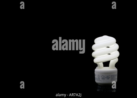 Compact Fluorescent bulb against a black backround with plenty of space for type Stock Photo