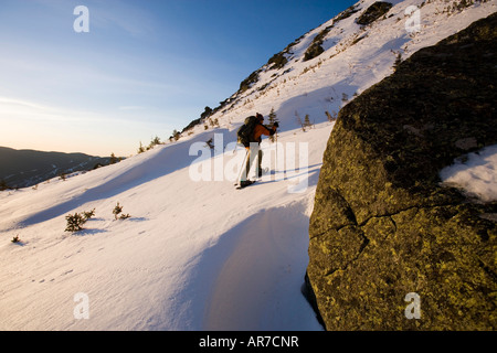 A man snowshoes in Tuckerman Ravine in New Hampshire s White Mountains Stock Photo