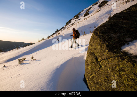 A man snowshoes in Tuckerman Ravine in New Hampshire s White Mountains Stock Photo