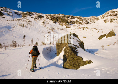 A man snowshoes in Tuckerman Ravine in New Hampshire s White Mountains Stock Photo