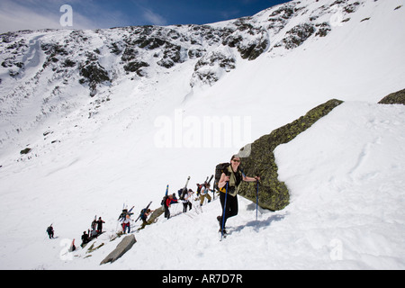 Skiers climbing Tuckerman Ravine in New Hampshire s White Mountains White Mountain National Forest April Stock Photo