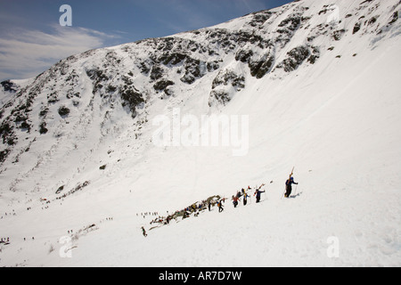 Skiers climbing Tuckerman Ravine in New Hampshire s White Mountains White Mountain National Forest April Stock Photo