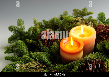 Christmas arrangement of burning candles and green spruce branches Stock Photo