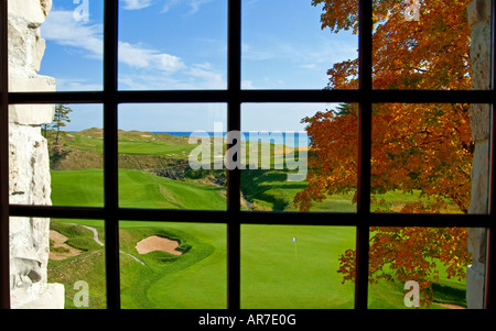 18th Hole through 2nd floor clubhouse window Whistling Straits Golf Course, Kohler, Wisconsin, USA Stock Photo