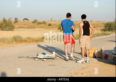 Two young males preparing a radio Controlled model aeroplane for takeoff Stock Photo