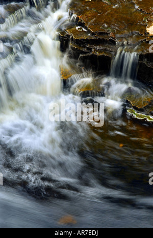 Waterfall cascading over natural rocks close up Stock Photo