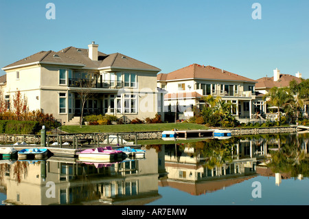 Exclusive waterfront homes on a private lake with boats Stock Photo